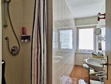 bathroom with shower and window