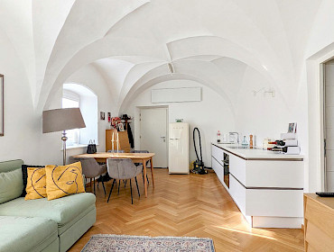 living room with arched ceiling